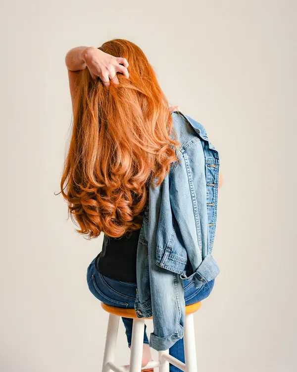 Pelo largo color cobrizo con ondas, visto de espalda